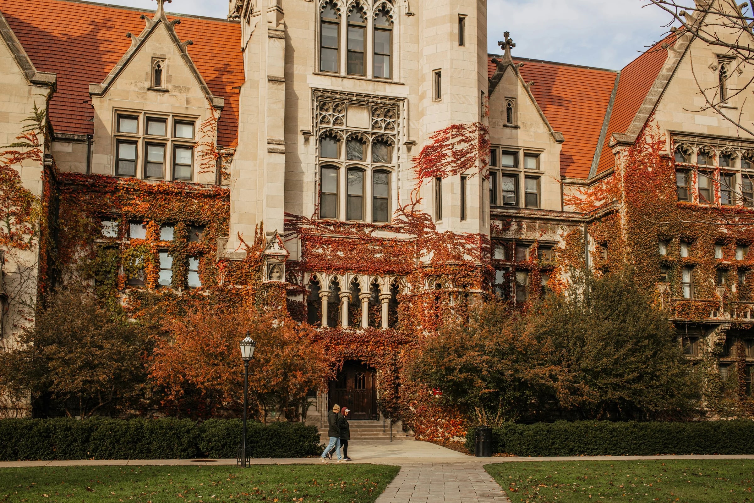Historic campus building framed by trees.